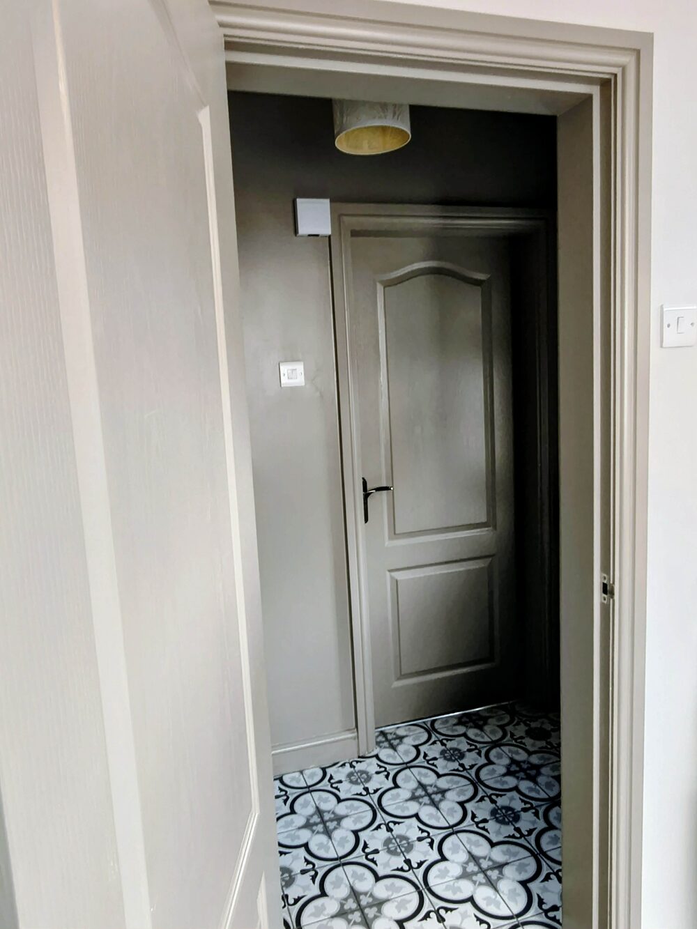 Hallway doors, frames and architrave repainted in grey-green water-based satin — the pre-sale and pre-let decorating standard applied to Southport properties