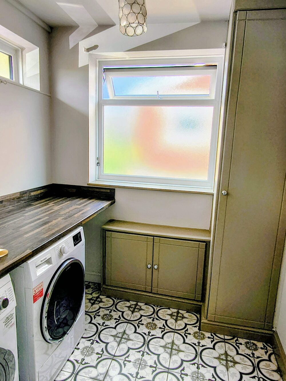 Utility room repainted in a hard-wearing grey-green scheme after full preparation — the same maintenance decorating done for Southport and Birkdale homes