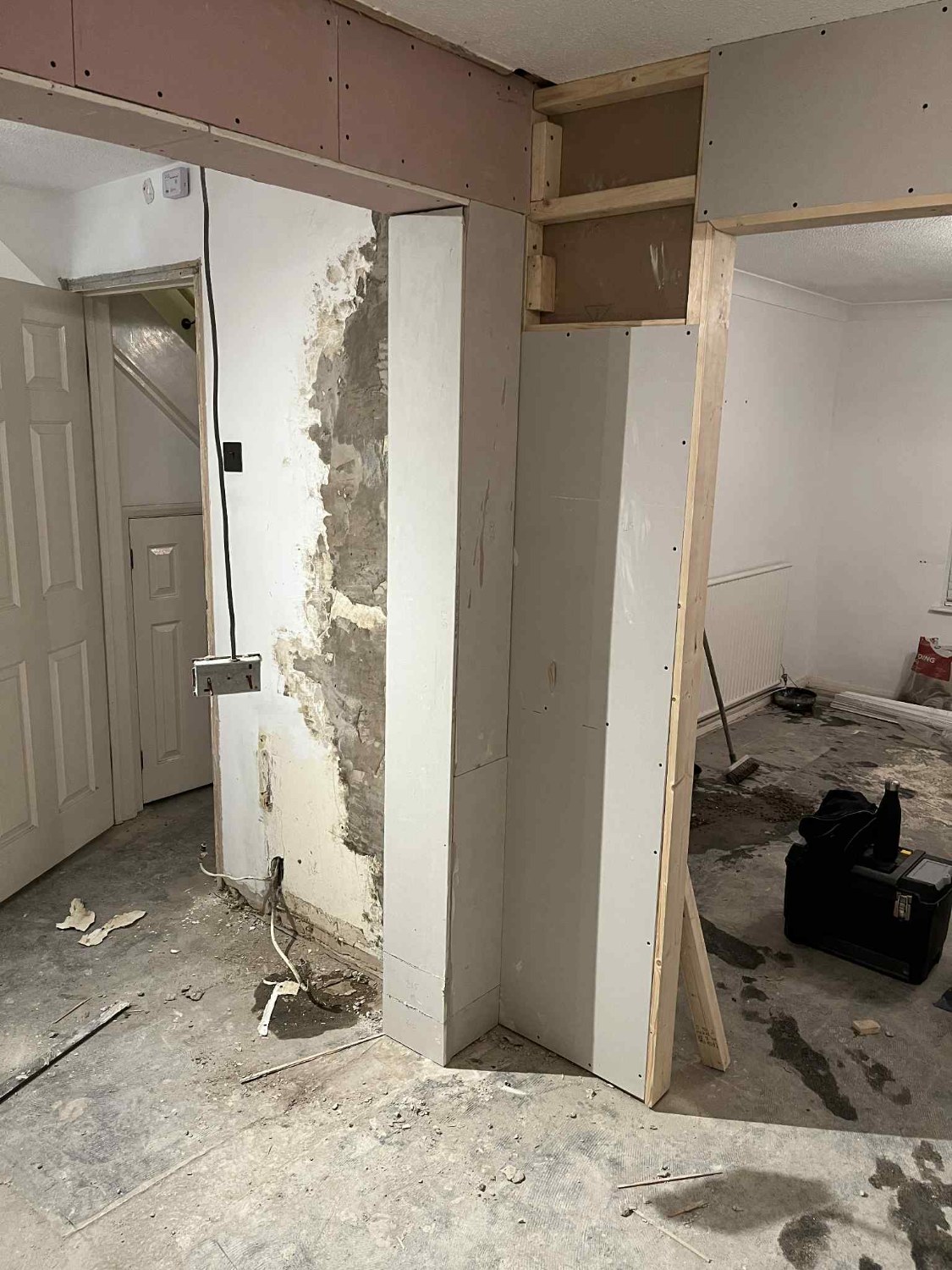 Structural steel beam boxed in with plasterboard and framing ready for skimming — the same open-plan plastering work done for Southport knock-throughs