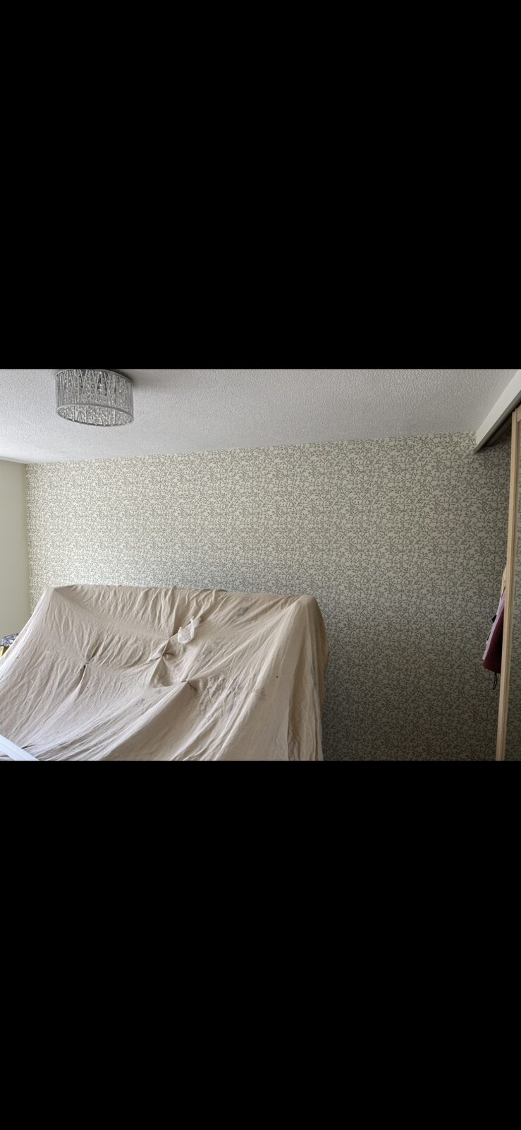 Sage green botanical trail patterned wallpaper feature wall hung with the pattern matched drop to drop — the same wallpaper hanging service across Southport PR8 and PR9